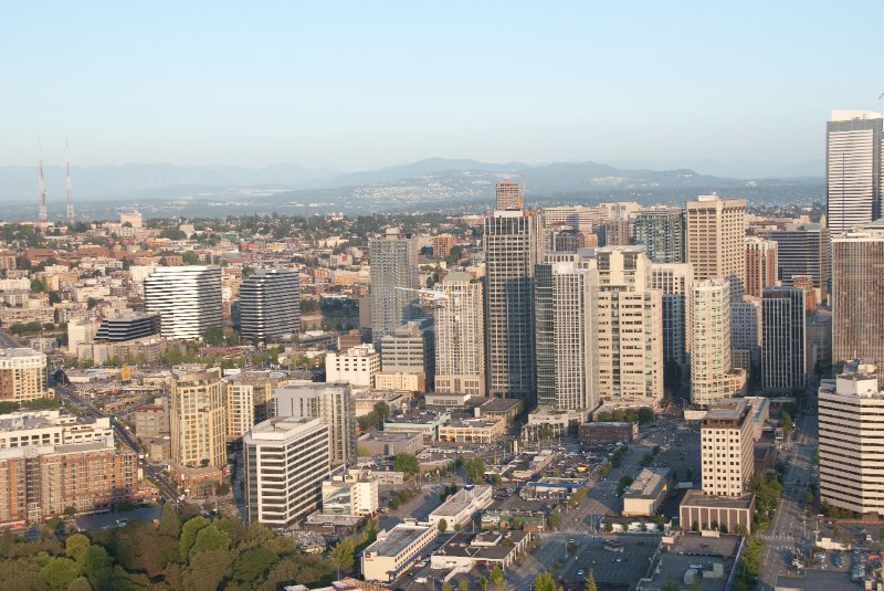 Seattle080309-8360.jpg - Airplane Flying Across Downtown Seattle Skyline as viewed from the SE side of the Space Needle