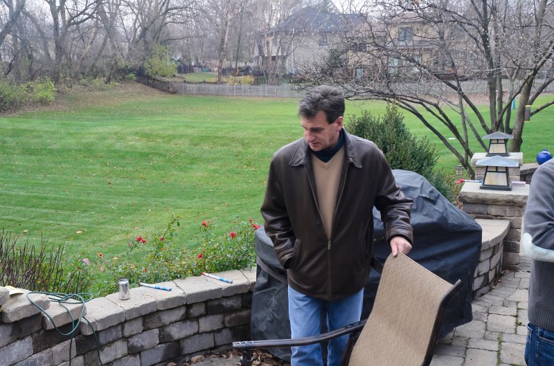 ThanksgivingNov2011-7336.jpg - Steve sitting down at the patio fire place