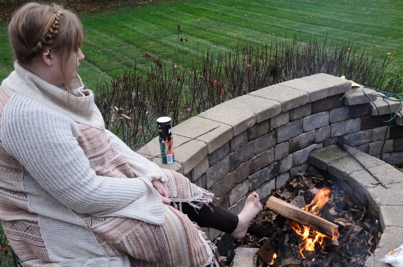 ThanksgivingNov2011-7337.jpg - Liz warming her feet on the patio fire