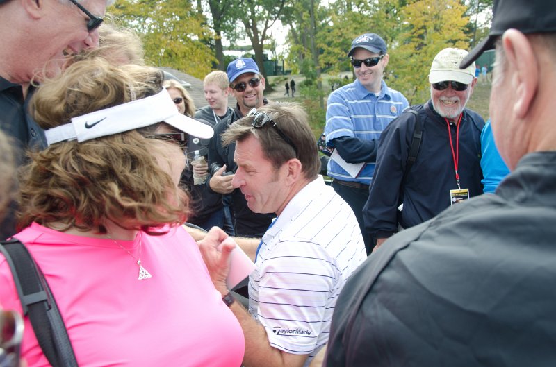 Rydercup092712-3415.jpg - Sir Nick drive a cart along the pedestrian bridge between hole 2 and 13
