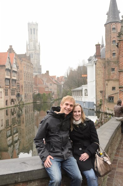 Bruges010413-4978.jpg - Mike and Liane at Rozenhoedkaai / Rose Hat Quay, at Groenerei (Green Canal) and Dijver canals. Belfort (background)