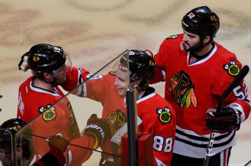 BlackHawks042613-6630.jpg - Blackhawks Jonathan Toews, Patrick Kane, and Brandon Bollig happy at the end of the Hawks vs Flames victory