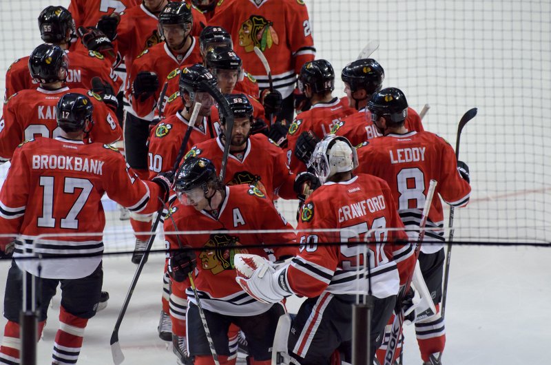 BlackHawks091713-8613.jpg - The team congratulates Crawford on a shutout against Detroit. Blackhawks vs Detroit preseason game
