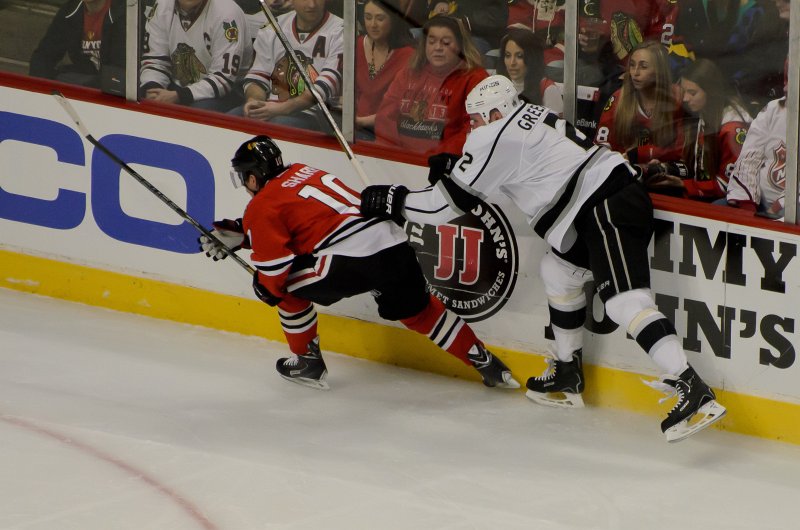 Blackhawks121513-9772.jpg - Patrick Sharp being held by a Green. Kings vs Blackhawks hockey, United Center, Chicago