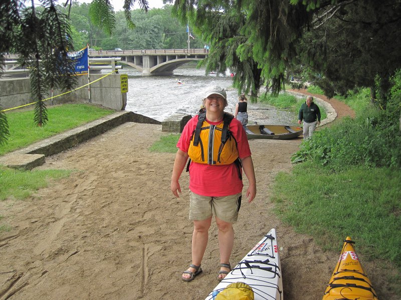 FoxRiverKayakRace060213-5331.jpg - Cathie on the North Aurora Dam Portage.  Butterfield Rd bridge in the background. Mid-American Canoe & Kayak Race paddling from St Charles to Aurora