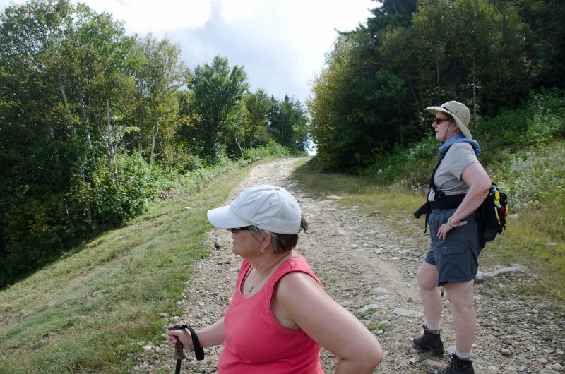 Maine090113-8252.jpg - Leslie and Cathie looking walking south along Three Mile Trail to Barker Mountain, Sunday River, crossing what looks like American Express ski run